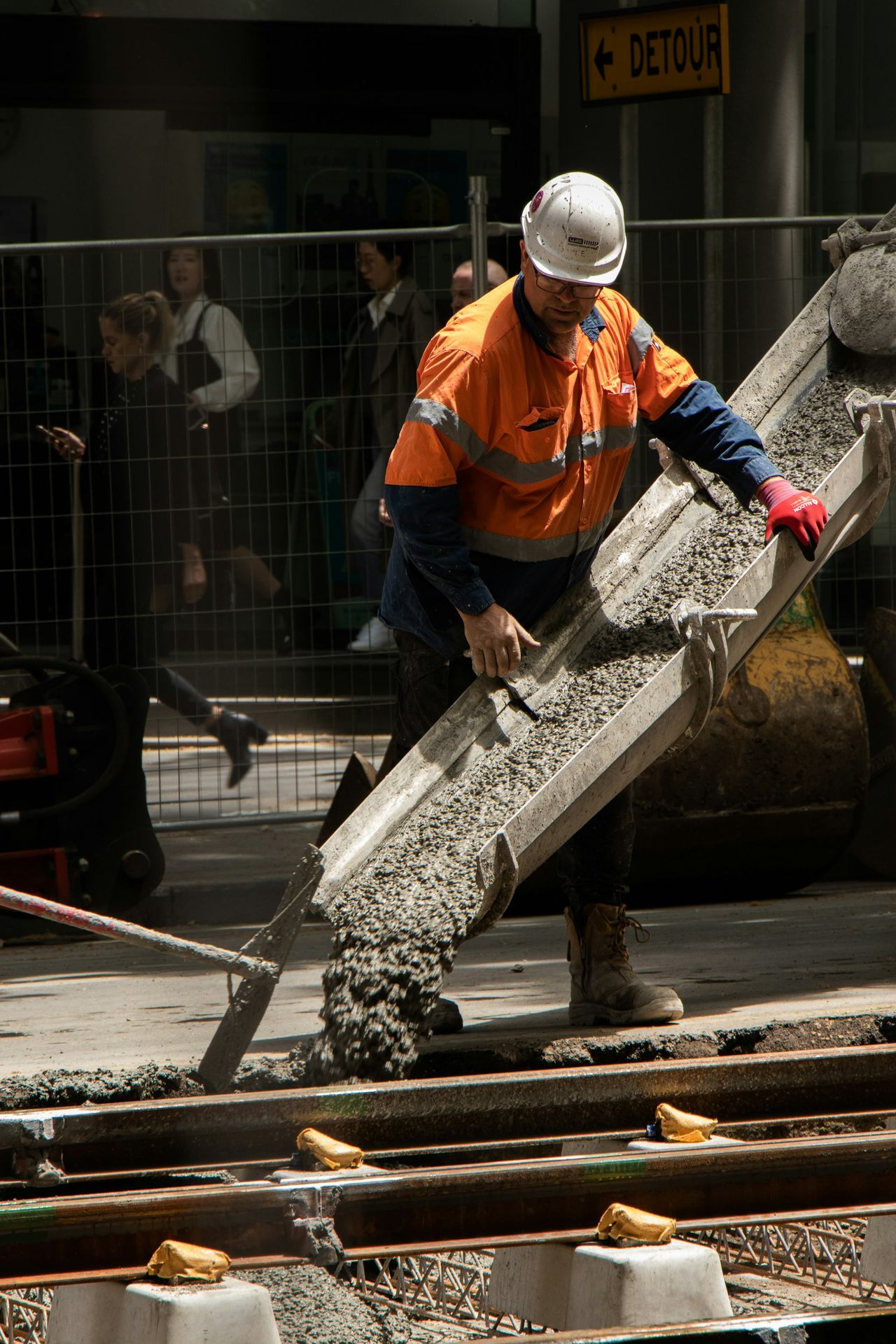 man pouring cements on road